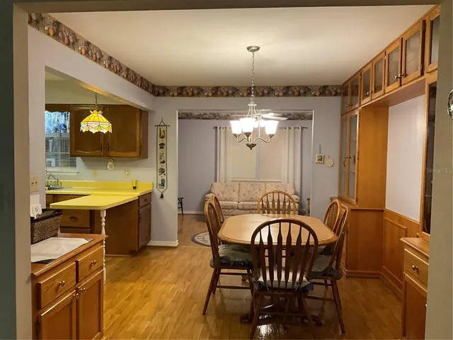 a view of a dining room with furniture and chandelier