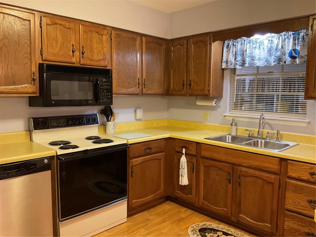 2438 Southeast 32nd Street Okeechobee, FL 34974 - Photo 42 of 42 a kitchen with stainless steel appliances a stove a sink and a microwave