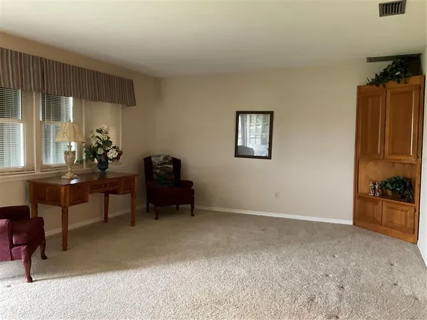 a living room with furniture a dining table and a piano