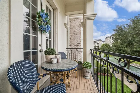 a view of a balcony with table and chairs