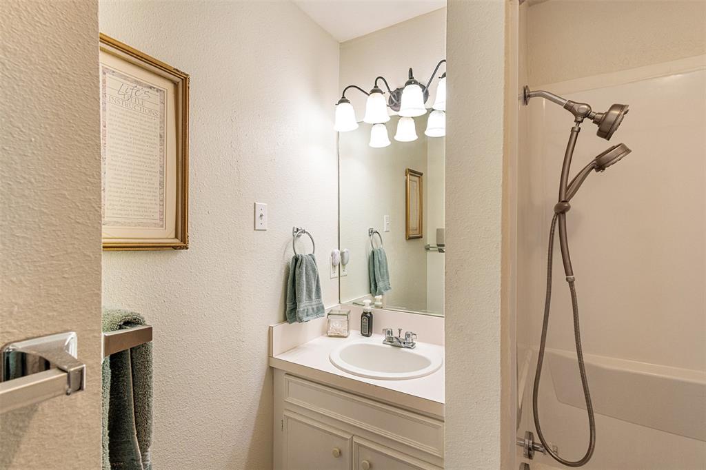 713 Midway Road Tool, TX 75143 - Photo 12 of 28 a bathroom with a sink a mirror and a shower