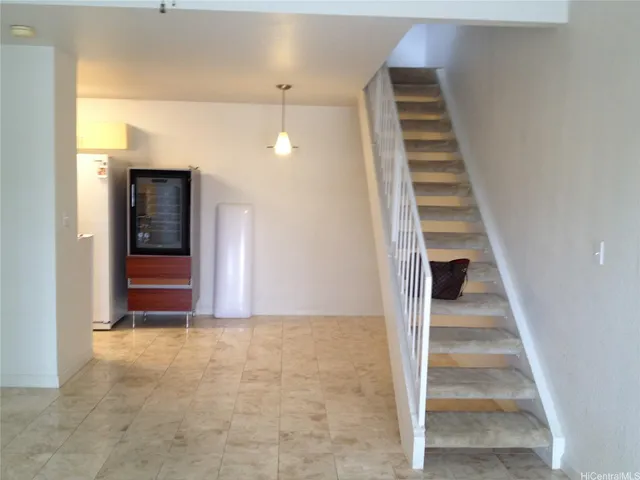 a view of a hallway with wooden floor and entryway