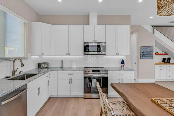 a kitchen with a refrigerator and cabinets