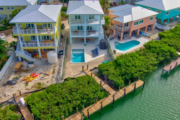 an aerial view of multiple houses with yard