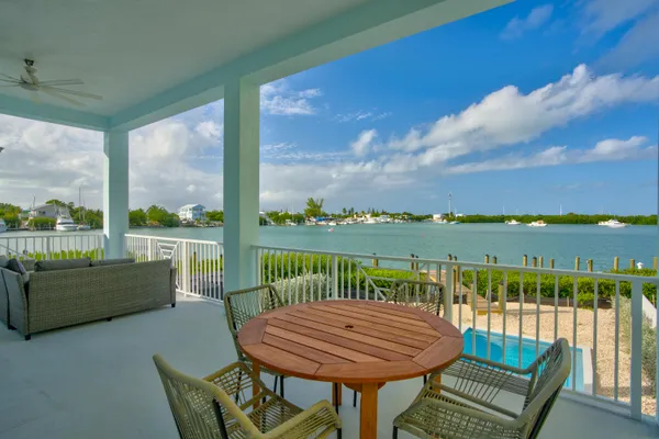 a view of a dining room with furniture large windows and wooden floor