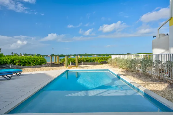 a view of a swimming pool with an outdoor seating and a yard
