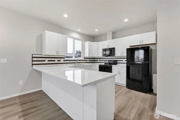 a kitchen with a sink a stove and refrigerator