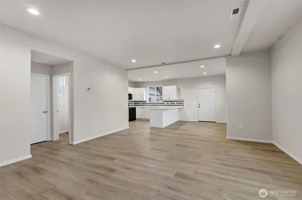a kitchen with granite countertop white cabinets and stainless steel appliances