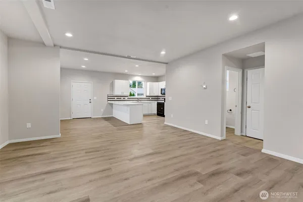 a view of kitchen with a sink cabinets and wooden floor
