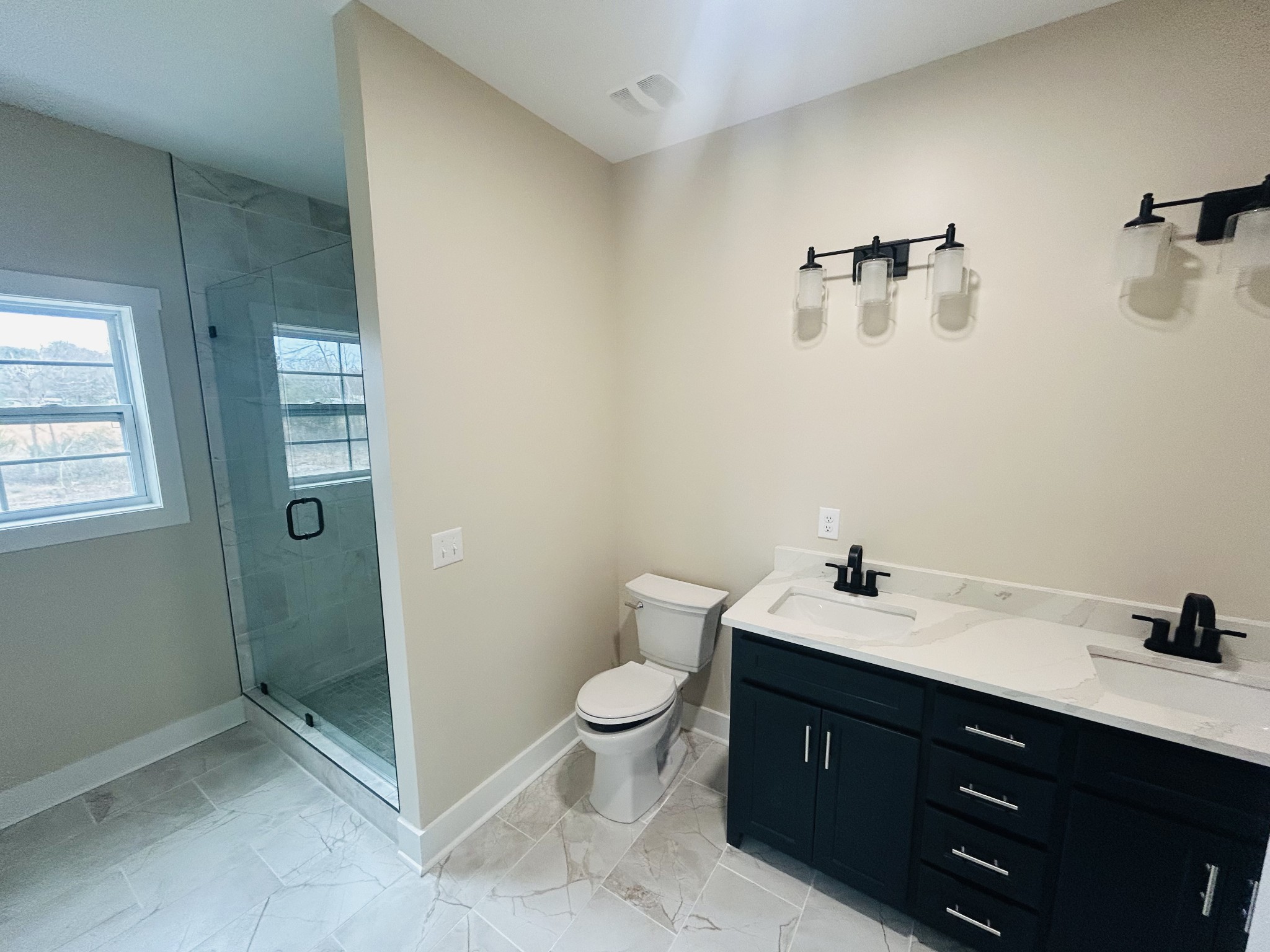 50 Aedc Lakeview Road Estill Springs, TN 37330 - Photo 15 of 25 a bathroom with a double vanity sink toilet and a mirror