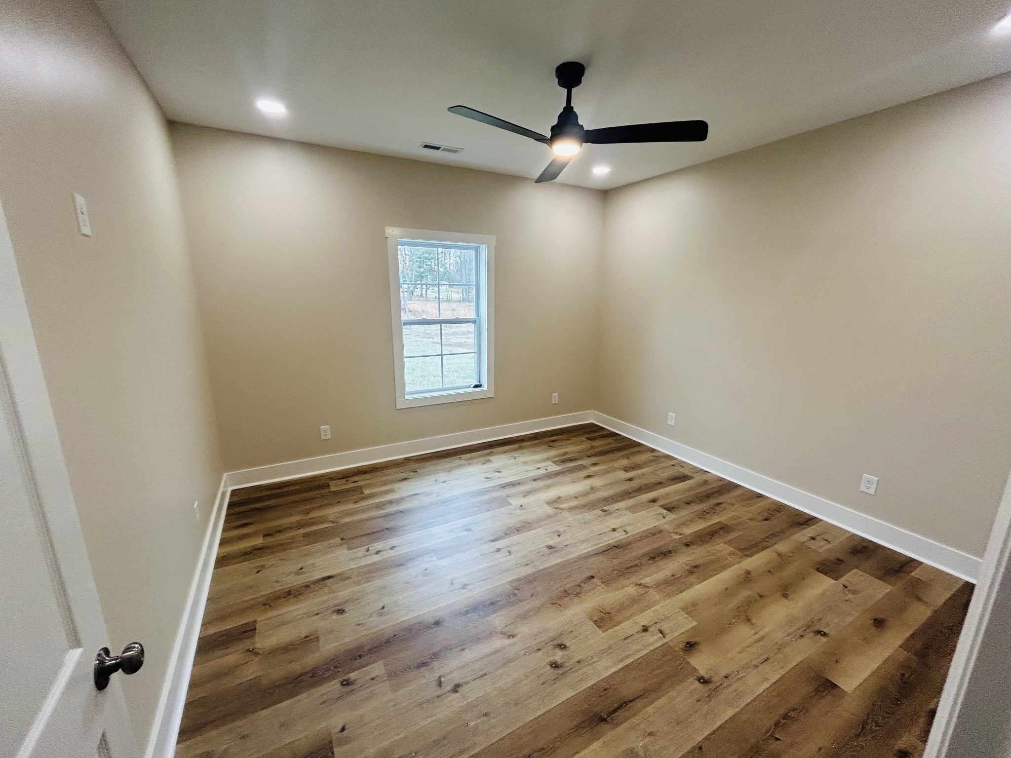 50 Aedc Lakeview Road Estill Springs, TN 37330 - Photo 18 of 25 an empty room with wooden floor and windows