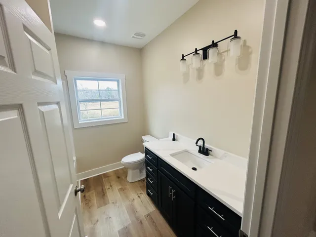 an empty room with wooden floor and window