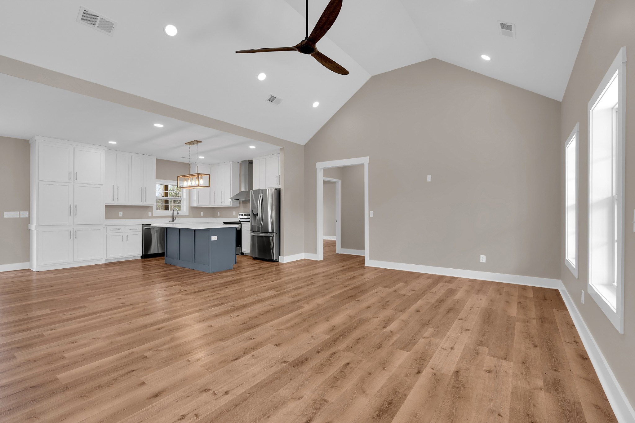 50 Aedc Lakeview Road Estill Springs, TN 37330 - Photo 7 of 22 a view of an empty room with wooden floor and a kitchen
