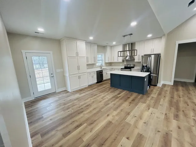 a kitchen with white cabinets and white appliances