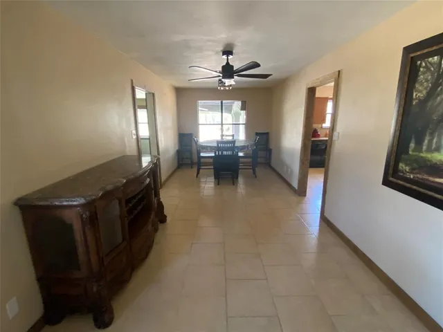 a kitchen with granite countertop a stove a sink dishwasher and a refrigerator with wooden floor