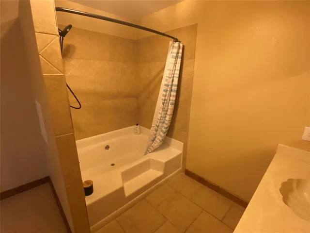 a bathroom with a bathtub and shower