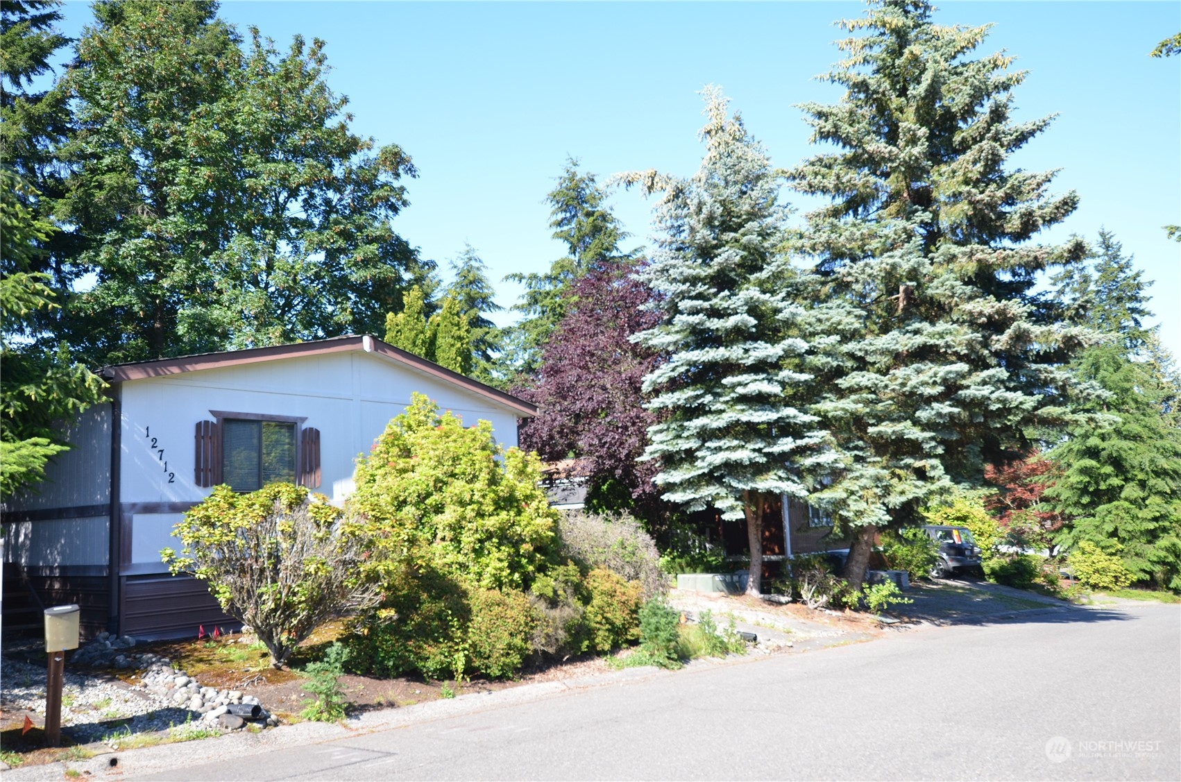 12712 Northeast 199th Street Bothell, WA 98011 - Photo 1 of 21 a front view of a house with a yard