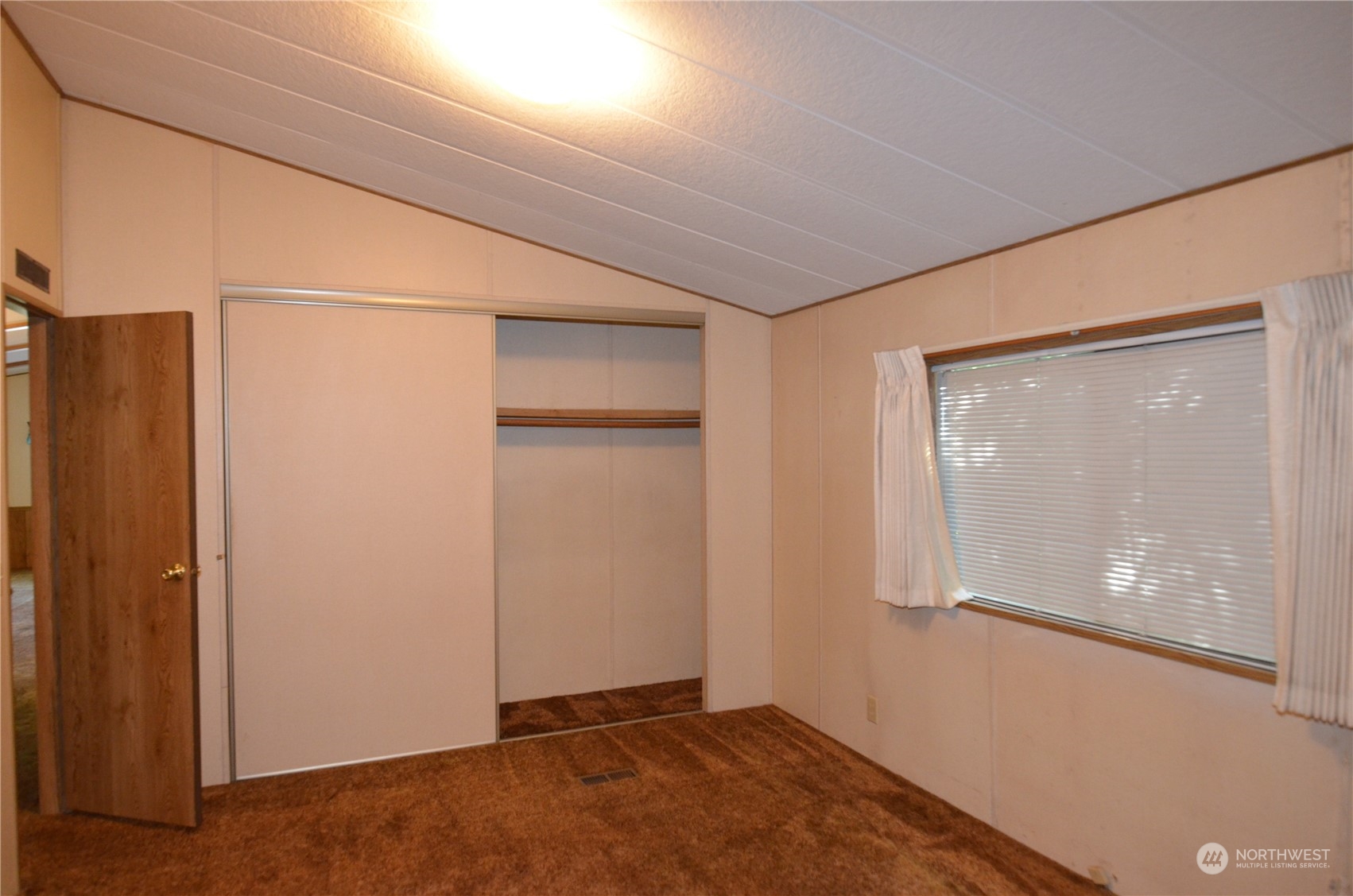 12712 Northeast 199th Street Bothell, WA 98011 - Photo 12 of 21 an empty room with windows