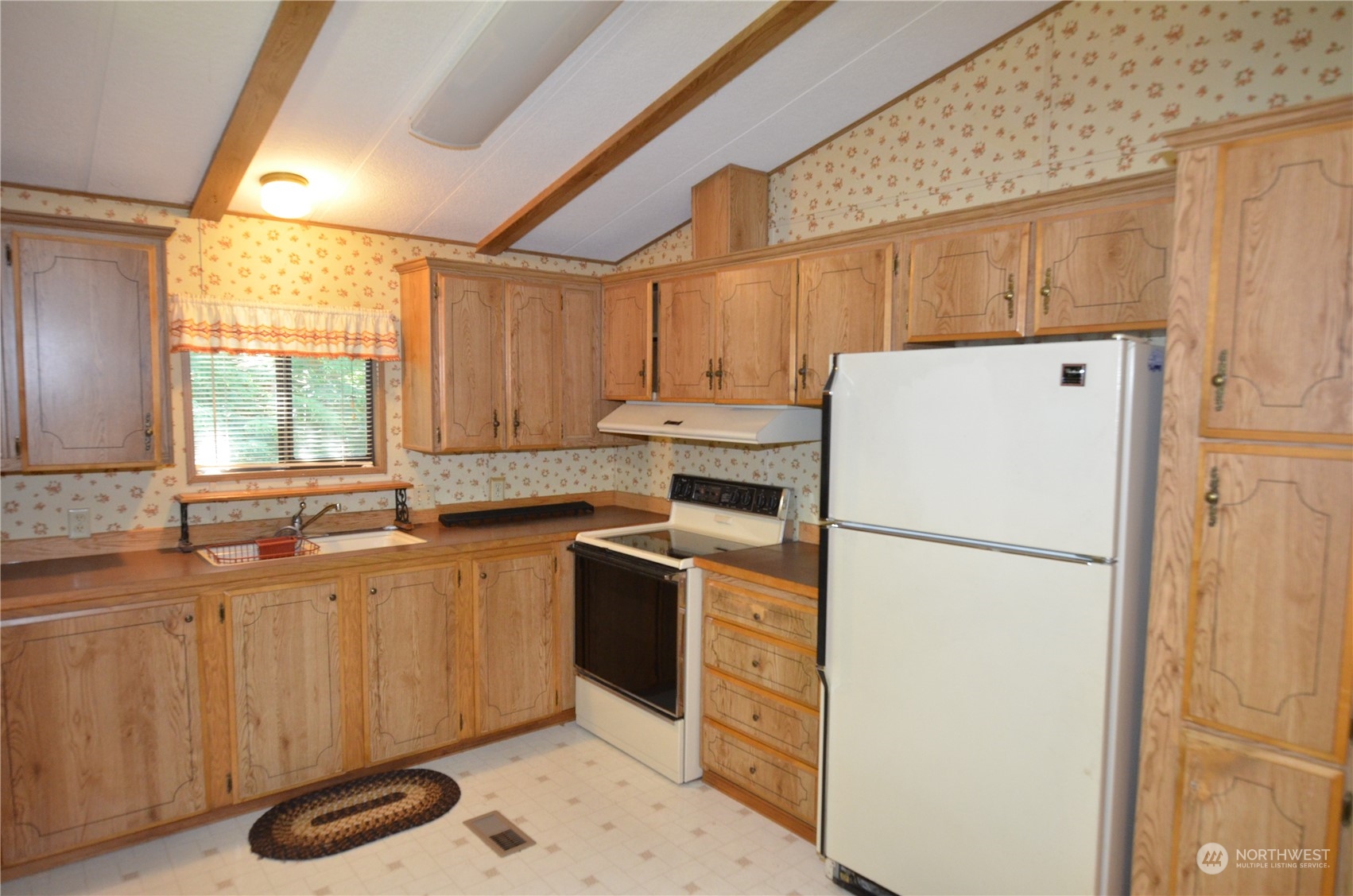 12712 Northeast 199th Street Bothell, WA 98011 - Photo 8 of 21 a kitchen with a refrigerator a stove a sink dishwasher and a microwave oven