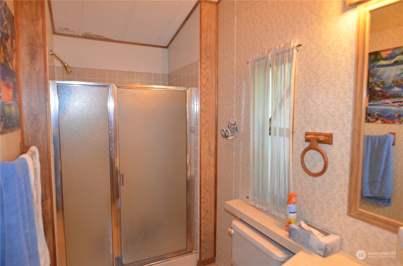 12712 Northeast 199th Street Bothell, WA 98011 - Photo 10 of 21 a bathroom with a shower and a mirror
