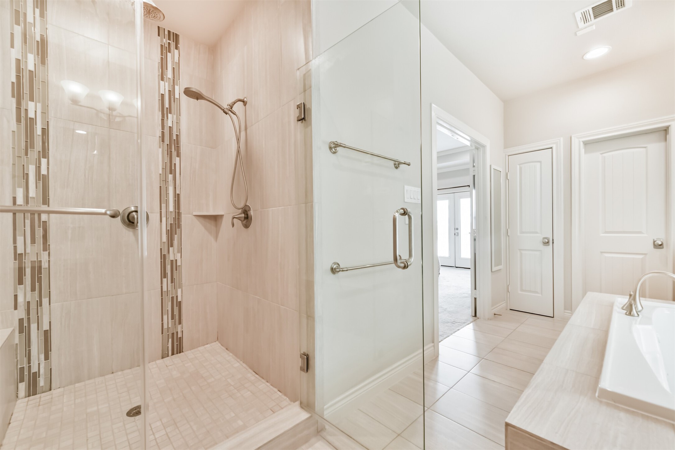 1321 Laird Street Houston, TX 77008 - Photo 13 of 25 Large walk-in shower with bench seating and dual heads. Linen closet and large walk-in closet.