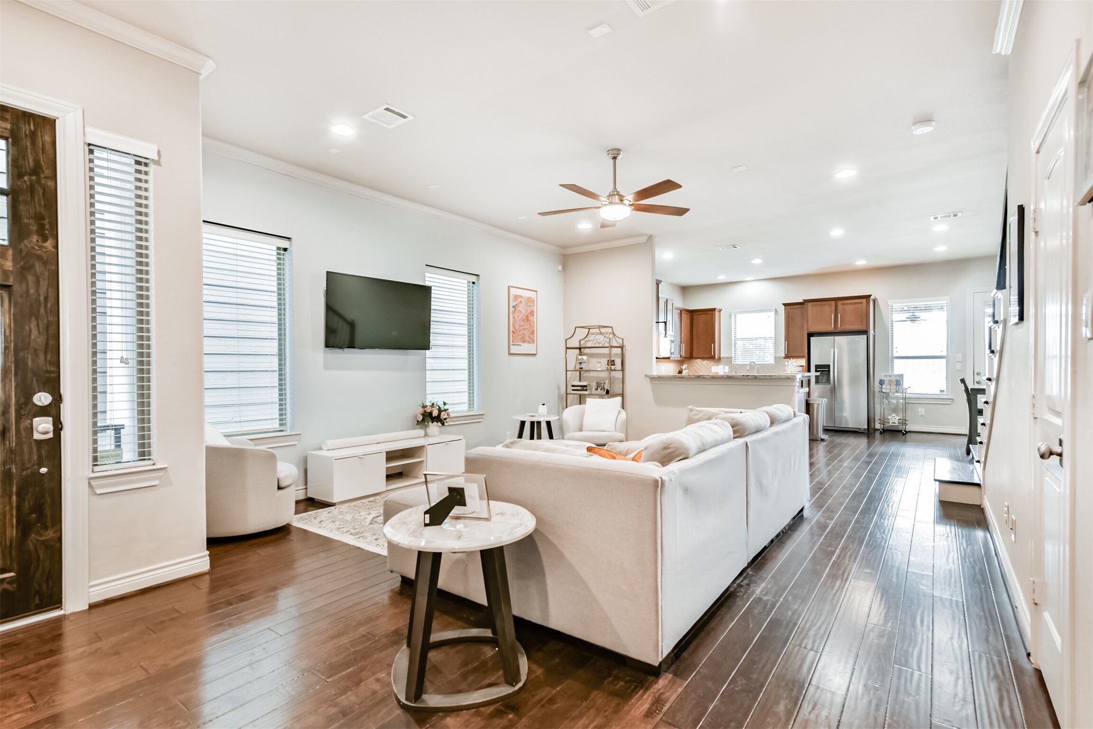 1321 Laird Street Houston, TX 77008 - Photo 4 of 25 The primary living area seamlessly connects to a spacious kitchen and dining zone. Elevated ceilings and expansive windows ensure abundant natural illumination.