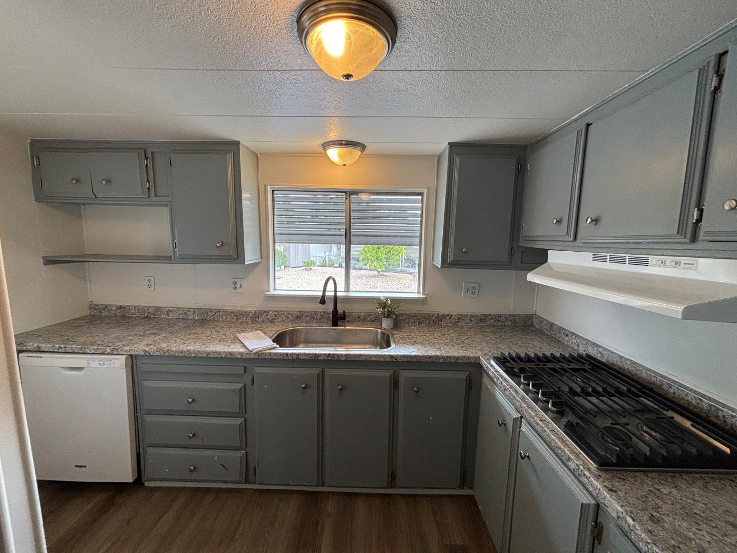 a kitchen with a sink stove and cabinets