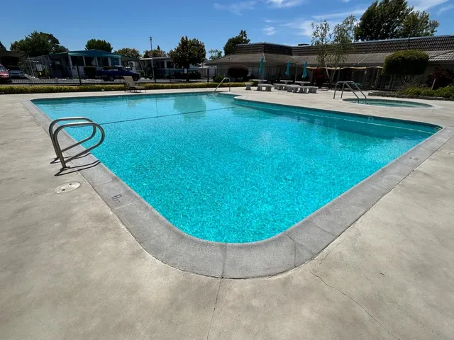 a view of a swimming pool with outdoor seating and yard