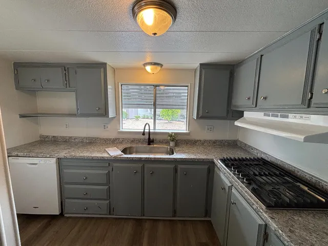 a kitchen with a sink stove and cabinets