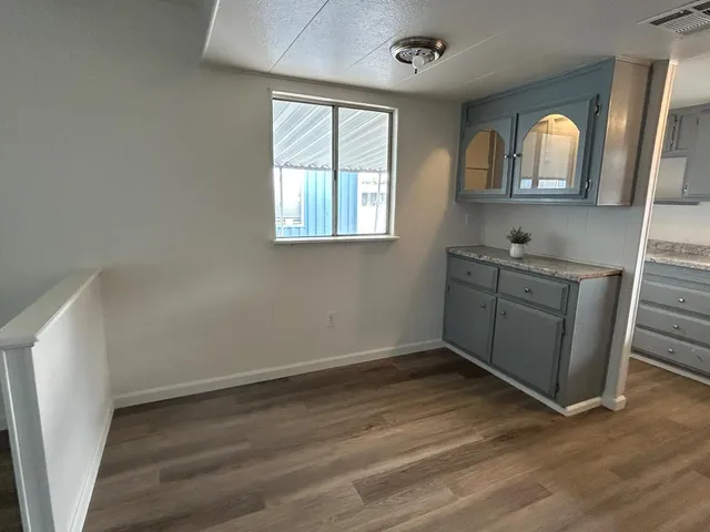 an empty room with wooden floor and window