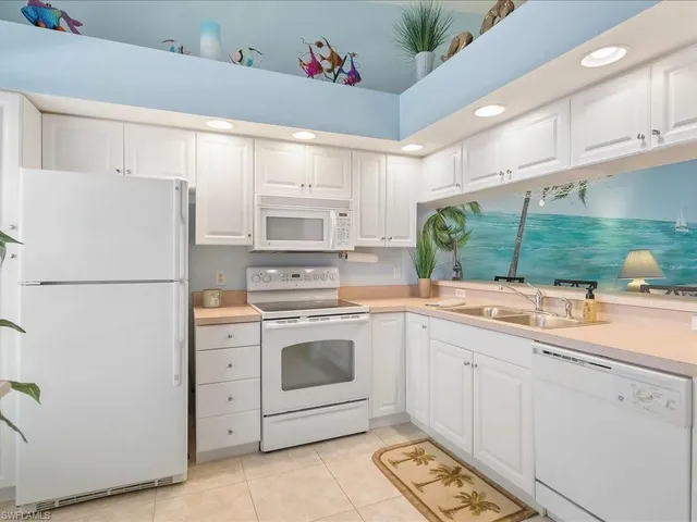 a kitchen with a white cabinets and white appliances
