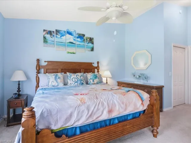 a bedroom with a bed and lamps