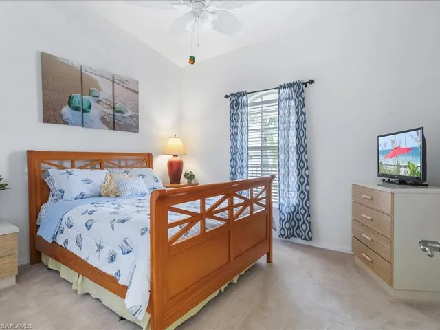 a bedroom with a bed and a dresser in it