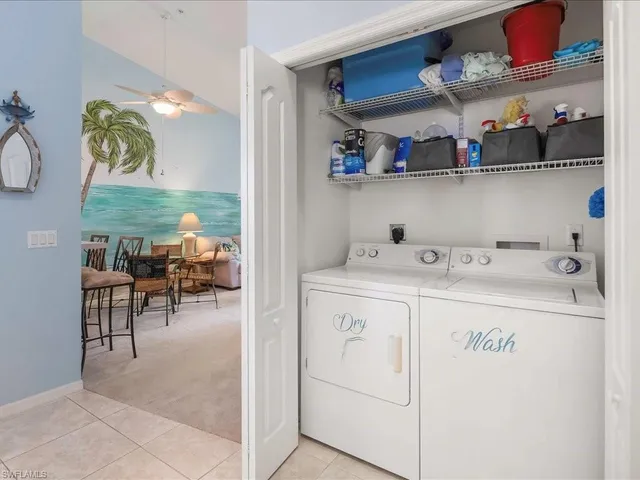 a utility room with multiple dryer and washer