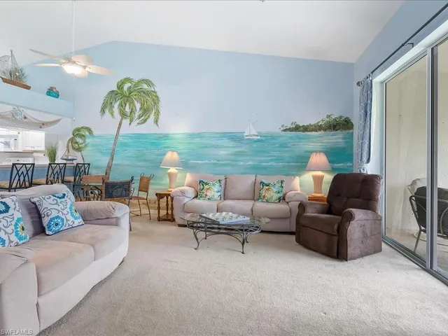 a living room with furniture and a floor to ceiling window