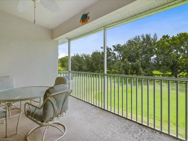 a view of a chair and tables in the balcony