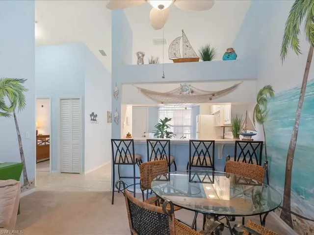a dining room with furniture a window and wooden floor