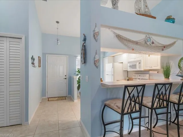 a dining room filled chandelier and wooden floor