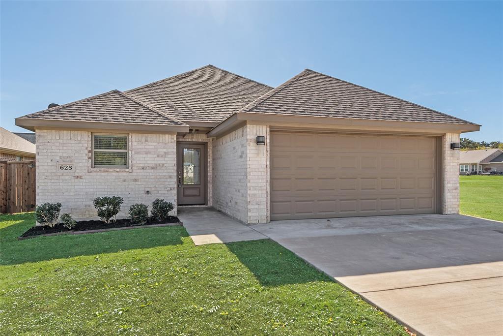 625 Copenhavr Street Pilot Point, TX 76258 - Photo 4 of 20 View of front of property with brick siding, a shingled roof, driveway, and a garage