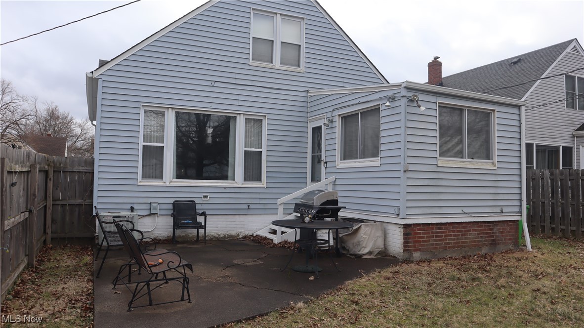 4213 Stonehaven Road Cleveland, OH 44121 - Photo 20 of 21 Rear view of house with a fenced backyard, a chimney, and a patio area