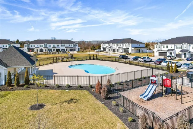 a view of a swimming pool with a table and chairs