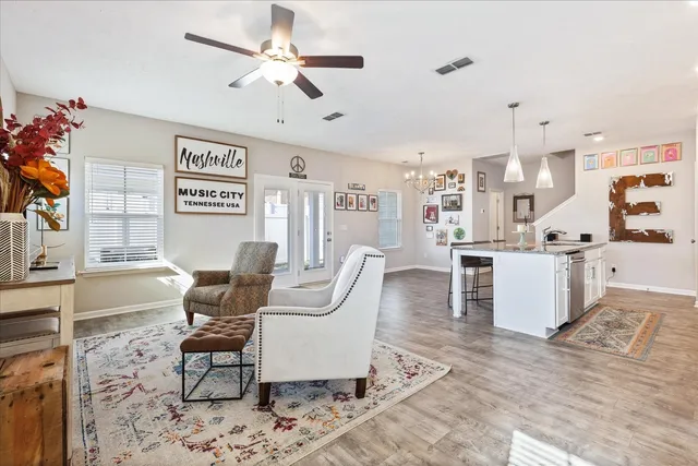 a living room with furniture and kitchen view
