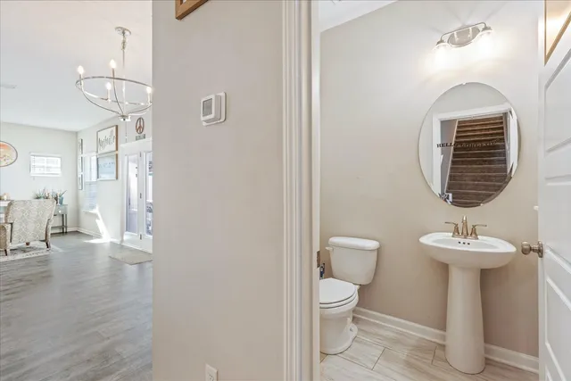 a view of bathroom with a toilet a sink and a mirror