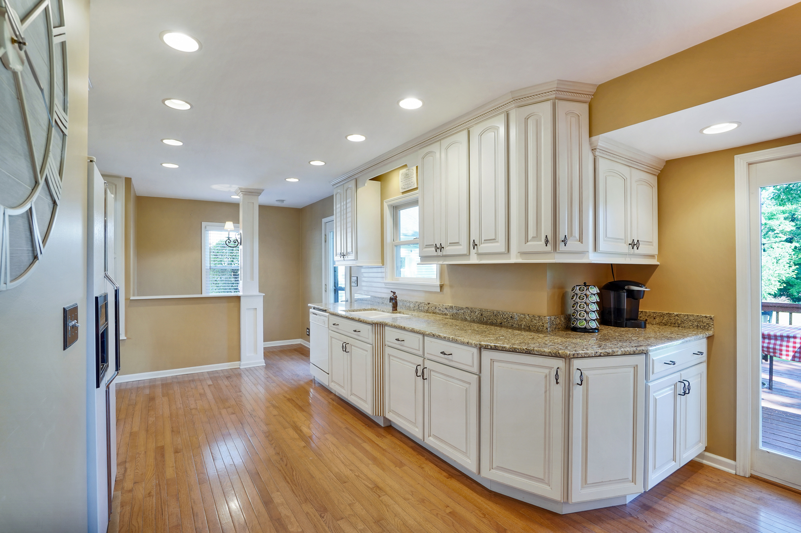 606 St Charles Road Glen Ellyn, IL 60137 - Photo 14 of 28 a kitchen with granite countertop a stove and a sink