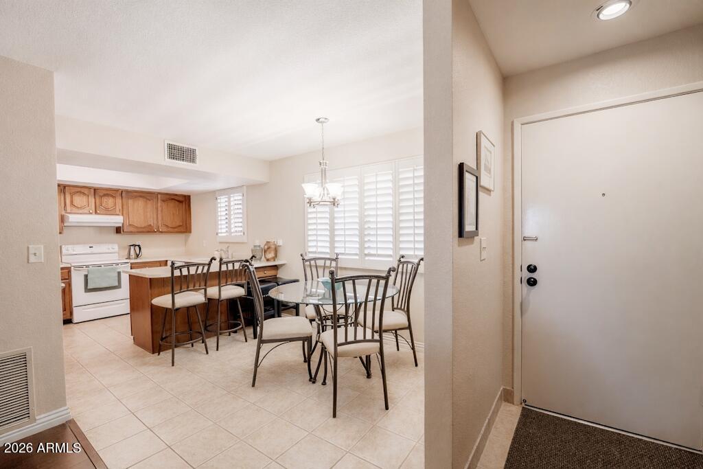 4303 East Cactus Road, Unit 403 Phoenix, AZ 85032 - Photo 11 of 37 a view of a dining room with furniture
