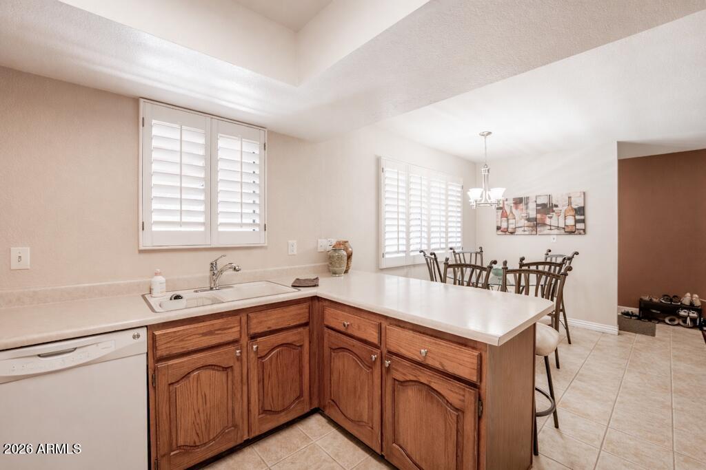 4303 East Cactus Road, Unit 403 Phoenix, AZ 85032 - Photo 12 of 37 a kitchen with sink cabinets and window