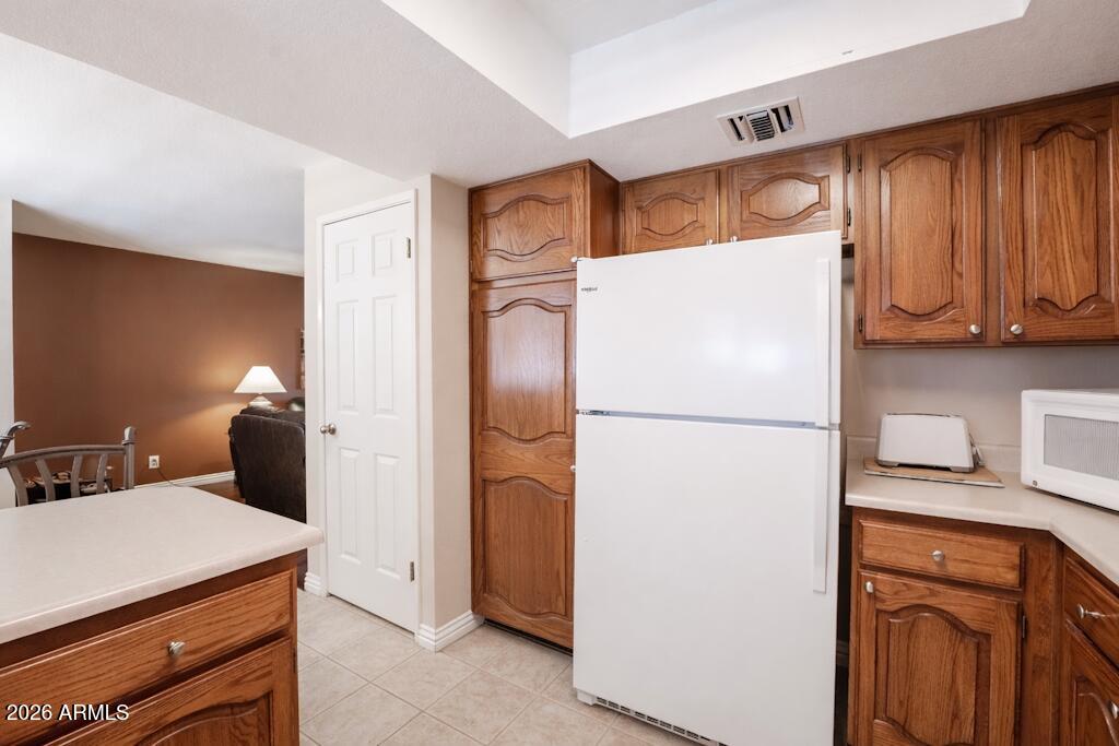 4303 East Cactus Road, Unit 403 Phoenix, AZ 85032 - Photo 13 of 37 a white refrigerator freezer sitting in a kitchen