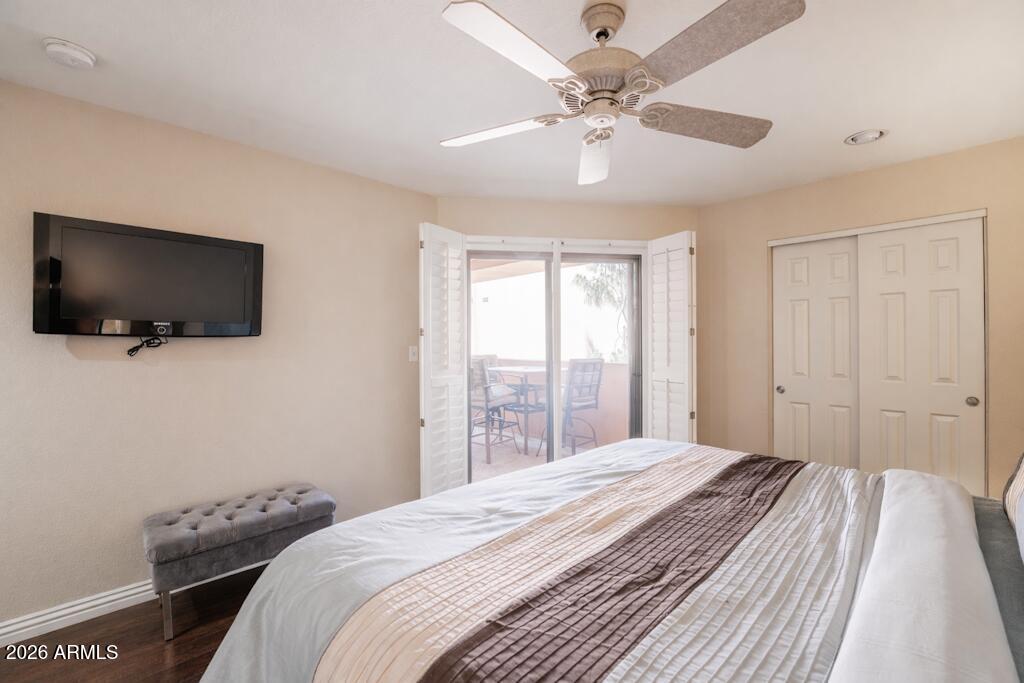 4303 East Cactus Road, Unit 403 Phoenix, AZ 85032 - Photo 15 of 37 a bedroom with a large bed and a flat screen tv