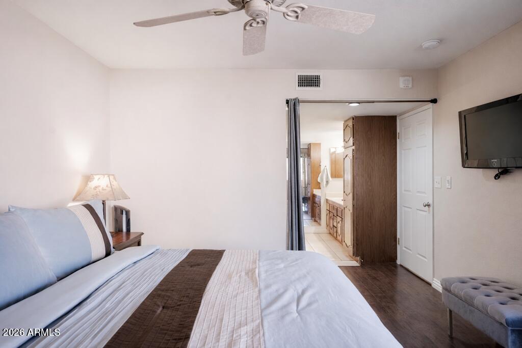 4303 East Cactus Road, Unit 403 Phoenix, AZ 85032 - Photo 16 of 37 a bedroom with a bed and a flat screen tv