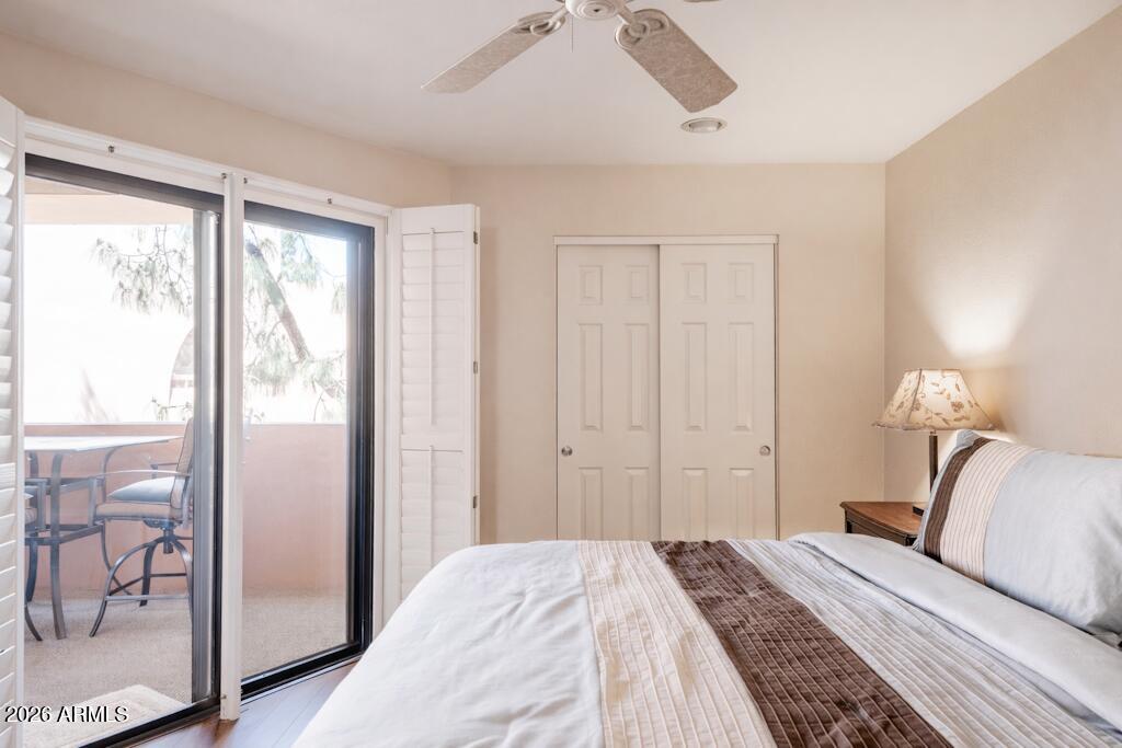 4303 East Cactus Road, Unit 403 Phoenix, AZ 85032 - Photo 17 of 37 a bedroom with a bed and a large mirror next to a window